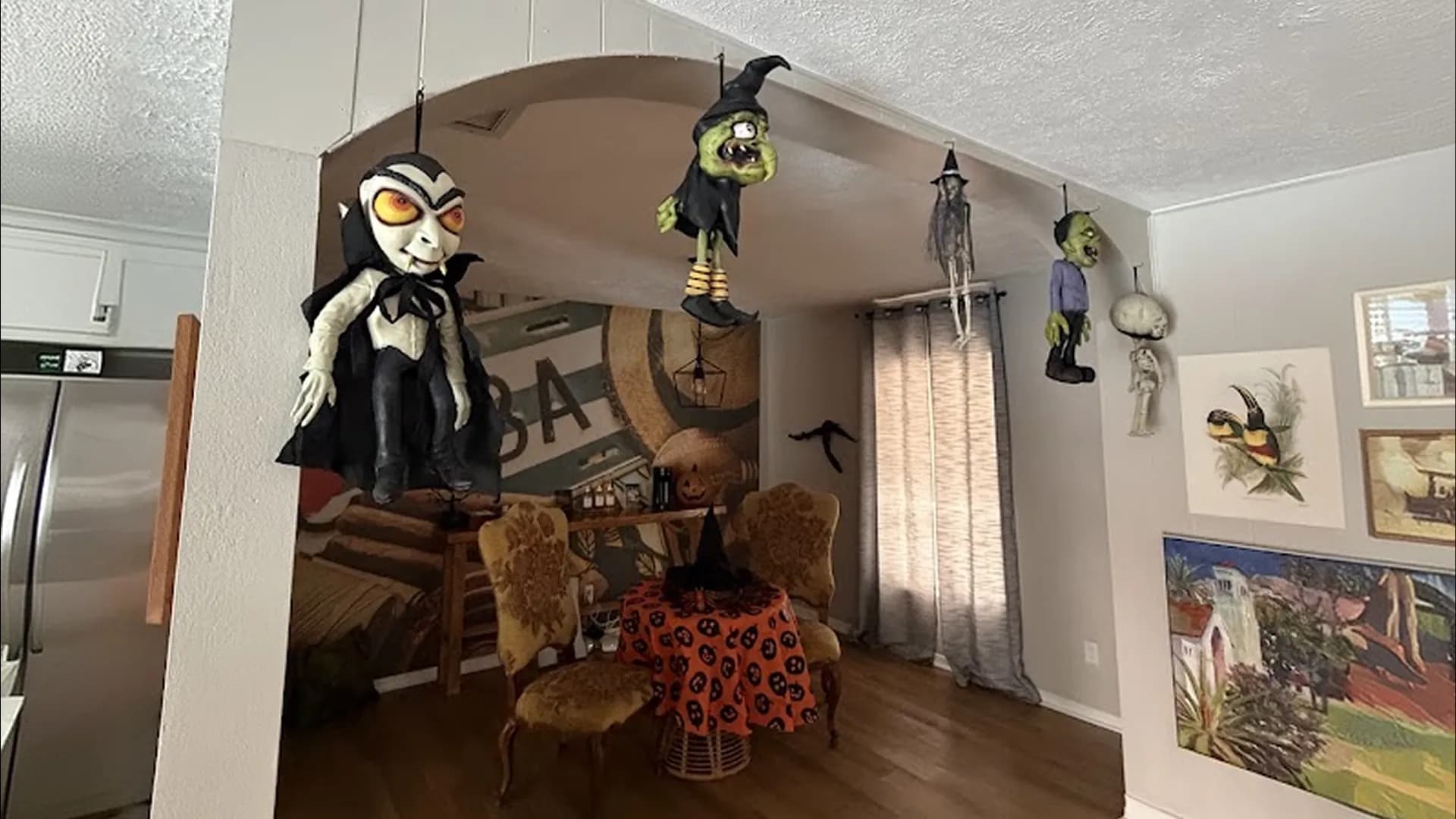 Clean, Halloween decorated living room with hanging skeleton decor ready for guests in St. Petersburg